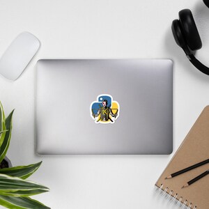 May include: A sticker featuring a stylized illustration of a person holding two swords, with the Python logo in the background. The logo is a yellow and blue clover shape.