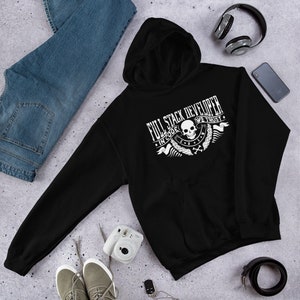 May include: Black hooded sweatshirt with a white graphic design featuring a skull and the text "Full Stack Developer In Code We Trust".