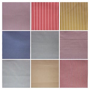 May include: Nine different fabric swatches with various striped patterns. The swatches include pink and white stripes, red and white stripes, yellow and white stripes, blue and white stripes, gray and white stripes, pink and white stripes, light blue and white stripes, beige and white stripes, and red and white stripes.