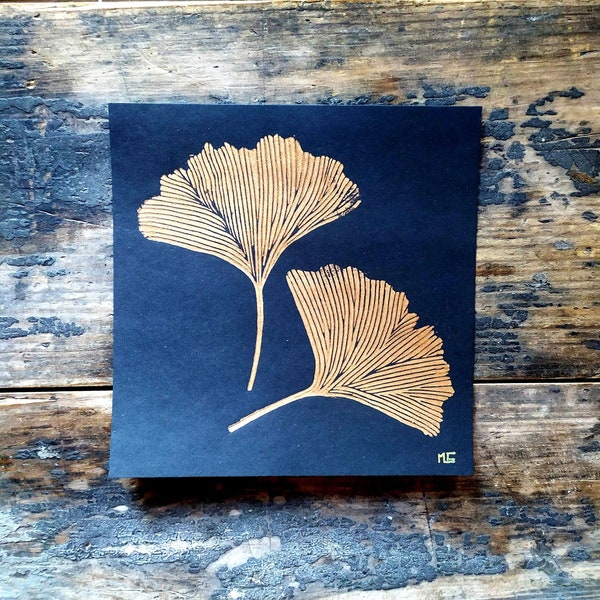 Linocut of Gingko Biloba leaves on black paper