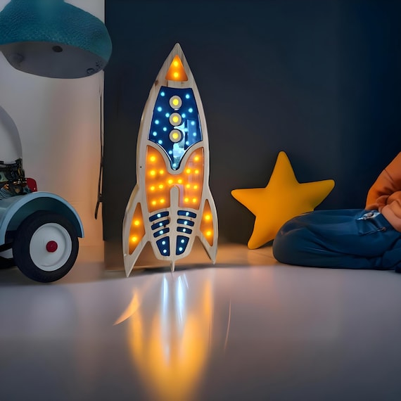 Pine wood rocket ship night light with epoxy details in a modern kids room