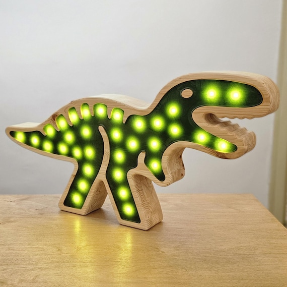 Eco-friendly wooden dinosaur lamp lit with green LEDs