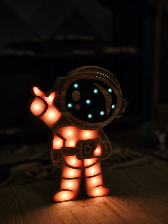 LED kids room lamp in the shape of a cartoon astronaut with a black visor