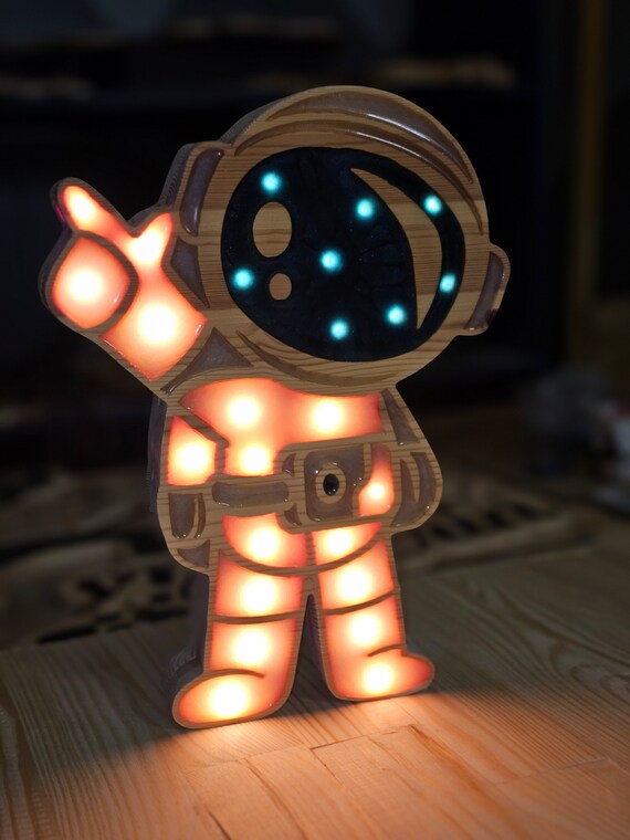 Space explorer night light for children, shaped like a waving astronaut
