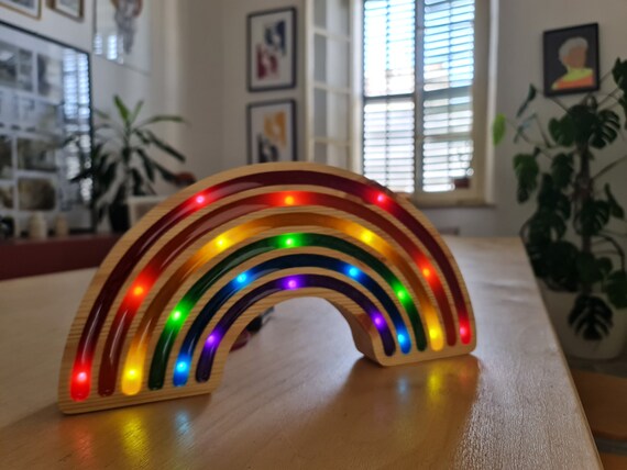 Eco-friendly LED rainbow lamp placed on a nursery dresser.