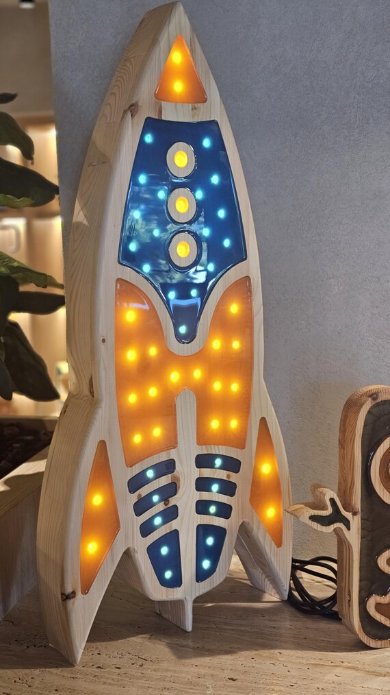 Tall wooden rocket lamp with blue and orange lights, perfect for space decor