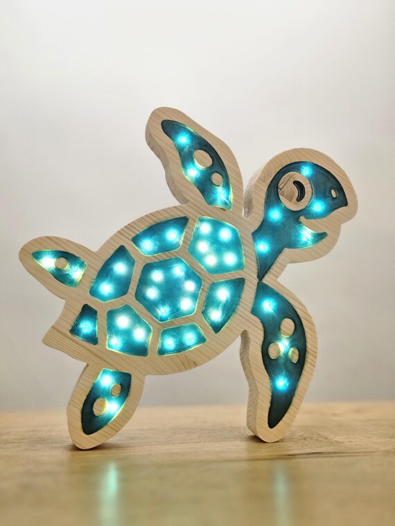 Handcrafted Caretta turtle lamp on a wooden table with warm lighting