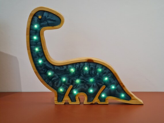 Side view of a handcrafted dino lamp made from pine wood and epoxy resin