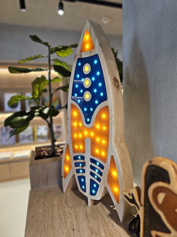 Colorful rocket ship lamp with LED lights creating a cozy nursery atmosphere