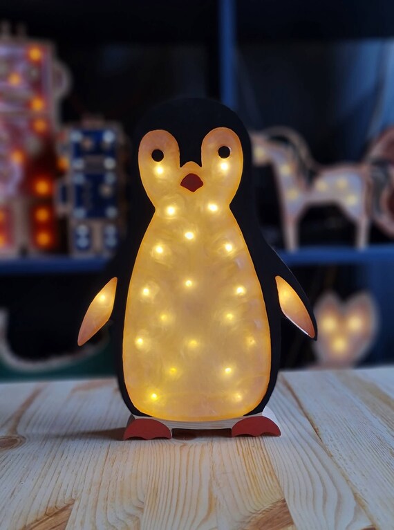 Handcrafted wooden penguin lamp with warm yellow lights