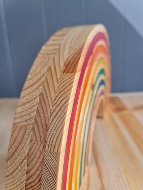 Colorful night lamp with a rainbow design adding warmth to a baby room.