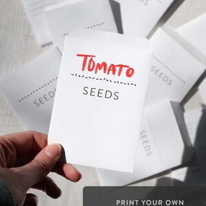 May include: A white seed packet with the text "TOMATO SEEDS" printed in red. The packet is being held by a hand. The text "PRINT YOUR OWN UNLIMITED SEED PACKETS! This is an instant download product" is printed below the packet.
