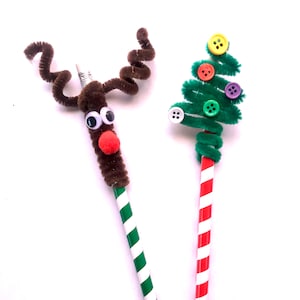 May include: Two decorated pencils, one with a green and white striped body and a green pipe cleaner shaped like a Christmas tree with colorful buttons, and the other with a red and white striped body and a brown pipe cleaner shaped like a reindeer with googly eyes and a red pom-pom nose.