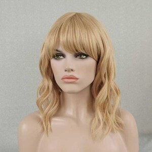May include: A shoulder-length blonde wig featuring soft waves and straight bangs. The hair is a light golden shade with subtle highlights, styled to frame the face with a layered cut that falls just past the shoulders in a natural, wavy texture.