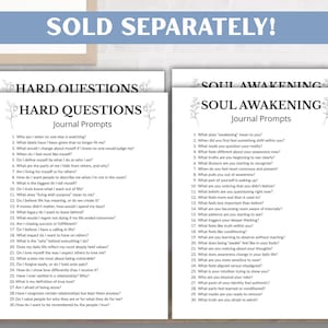 May include: Two white journal pages with black text, titled "Hard Questions" and "Soul Awakening." Each page lists journal prompts. The phrase "SOLD SEPARATELY!" is at the top. The pages are on a wooden surface.