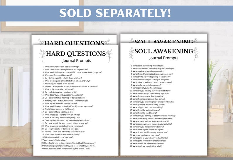 May include: Two white journal pages with black text, titled "Hard Questions" and "Soul Awakening." Each page lists journal prompts. The phrase "SOLD SEPARATELY!" is at the top. The pages are on a wooden surface.