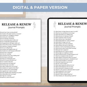 May include: A digital tablet and a printed page display journal prompts for self-reflection. The text "RELEASE & RENEW Journal Prompts" is at the top, with a list of questions below. The image is designed to help with mental health and personal growth.