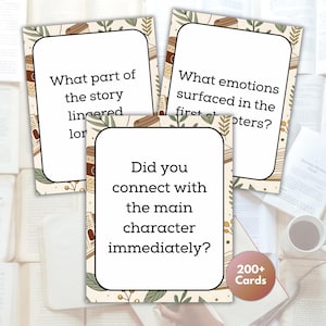 May include: Three reading prompt cards with text, including "What part of the story lingered?" and "Did you connect with the main character immediately?" The cards have a beige border with botanical and coffee cup illustrations. A "200+ Cards" sticker is visible.