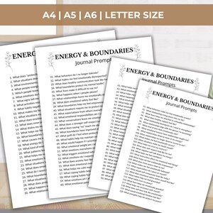 May include: A stack of white paper sheets with the text "ENERGY & BOUNDARIES Journal Prompts" printed in black. The papers are in A4, A5, A6, and Letter sizes. The text includes a list of journal prompts.