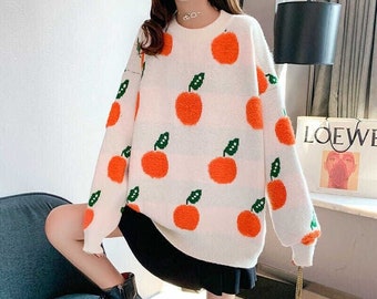 sweater with oranges on it