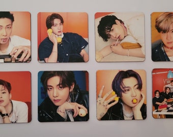 May include: A set of 10 photo cards featuring a group of seven men. The cards are square and have a white border. The photos are in color and show the men in various poses. Some of the men are wearing hats, sunglasses, and jewelry. The cards are printed on a glossy paper.