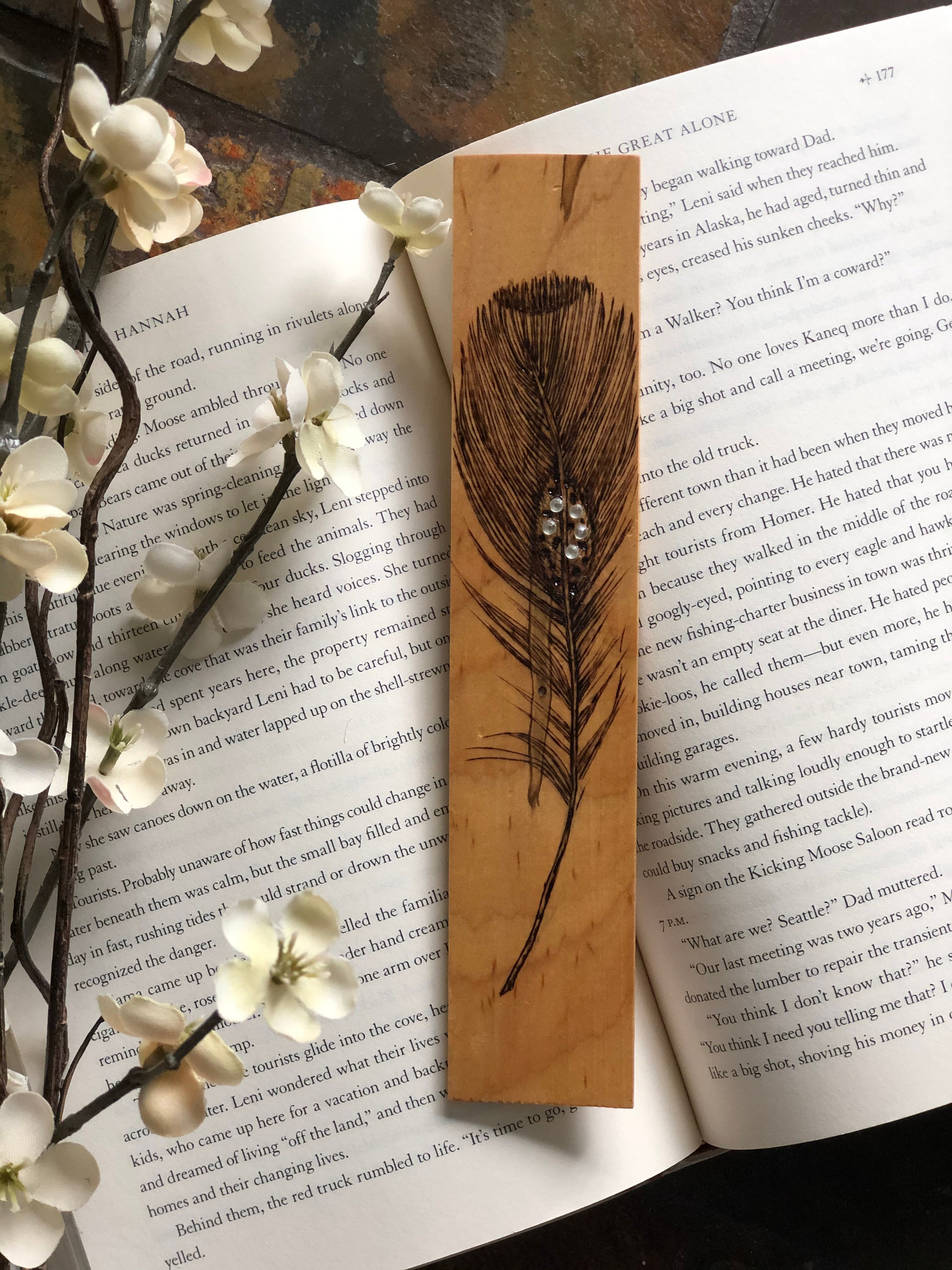 I got my dad to create some of his wood bookmarks for my favourite book  series. He carefully burns the design into the wood by hand using an  artistic technique called pyrography. 