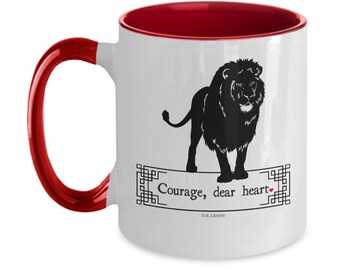May include: White ceramic mug with a red interior and handle. The mug features a black silhouette of a lion with the text "Courage, dear heart" and "C.S. Lewis" below the lion.