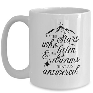 May include: White ceramic coffee mug with a black mountain range design and the text "To the stars who listen & the dreams that are answered".