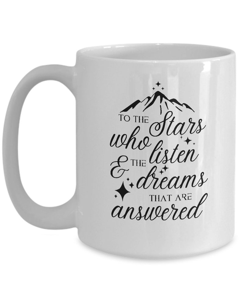 May include: White ceramic coffee mug with a black mountain range design and the text "To the stars who listen & the dreams that are answered".