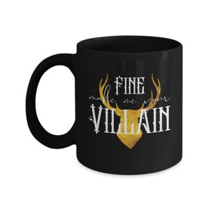May include: Black coffee mug with a gold deer head and the text "Fine make me your VILLAIN" in white.