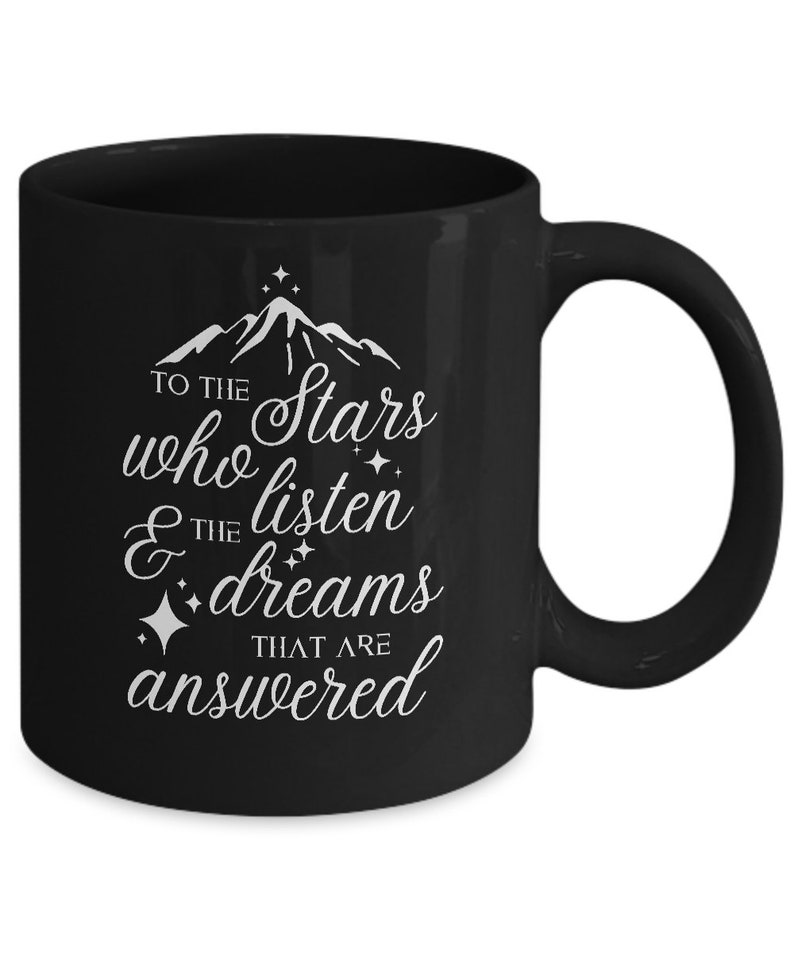 May include: Black coffee mug with white text that reads "To the stars who listen & the dreams that are answered". The text is surrounded by small stars.