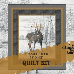 May include: A quilt kit featuring a framed image of a white-tailed deer in a forest setting. The kit includes fabric for a quilt measuring 58 inches by 65 inches. The kit is titled "Framed Deer Quilt Kit" and is from the brand "Stashes of Stuff".