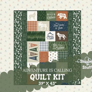 May include: A green and brown quilt kit with a camping theme. The kit includes a variety of fabrics with different patterns and designs, including a plaid pattern, a forest pattern, and a pattern with the words "Adventure is Calling". The kit is 39 inches by 43 inches.