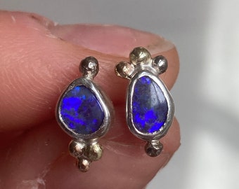 Violet boulder opal earring studs. Sterling silver, 14 k white gold and 14 k yellow gold details.