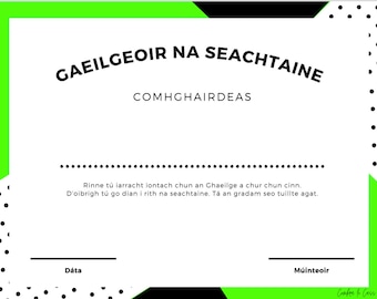 May include: A black and white certificate with green accents. The text reads "GAEILGEOIR NA SEACHTAINE COMHGHAIRDEAS". The text below reads "Rinne tú iarracht iontach chun an Ghaeilge a chur chun cinn. D'oibrigh tú go dian i rith na seachtaine. Tá an gradam seo tuillte agat."