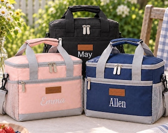 May include: Three rectangular insulated lunch bags in black, light pink, and navy blue. Each bag features a top handle, a zippered main compartment, a front zippered pocket with a brown label reading BEENLOVE, and side mesh pockets. Names May, Emma, and Allen are embroidered on the front.