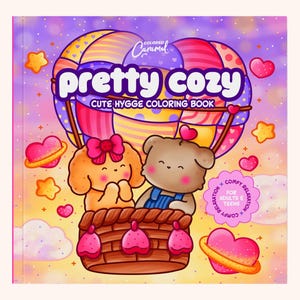 May include: A square coloring book titled Pretty Cozy Cute Hygge Coloring Book by Colored Caramel. The cover features a brown bear and a tan dog in a colorful hot air balloon basket, surrounded by pink hearts and yellow stars on a gradient background.