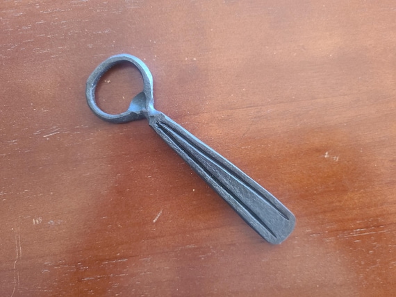 Forged-by-hand bottle opener with visible hammer marks — a tactile, rustic piece of functional blacksmithing that feels genuinely one-of-a-kind.