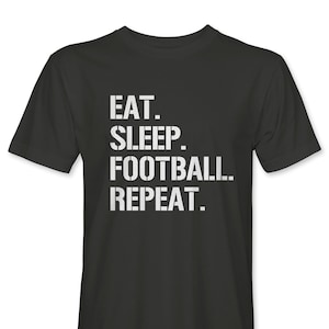 May include: A black t-shirt with white text that reads "Eat. Sleep. Football. Repeat."