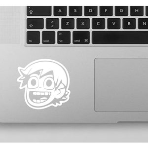 May include: A white sticker of a cartoon character with a wide smile and large eyes. The character has short, spiky hair and is wearing glasses.