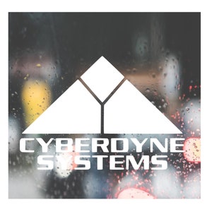 May include: White logo on a blurry background of city lights seen through a rain-streaked window. The logo is a stylized triangle with a smaller triangle inside. The text "CYBERDYNE SYSTEMS" is below the logo.