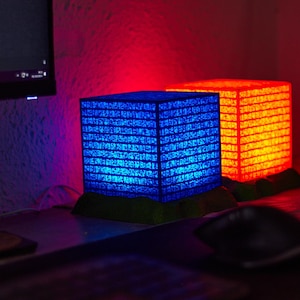 oneglyph rojo y azul emiten un resplandor conjunto, proyectando un aura de misterio y poder. Sus inscripciones antiguas, iluminadas en tonos cálidos y fríos, parecen contener secretos opuestos y complementarios