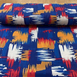 May include: Blue fabric with a colorful abstract print. The print features brushstrokes in shades of red, orange, yellow, and white.
