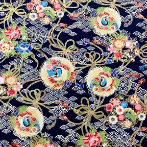 May include: A navy blue fabric with a repeating pattern of gold, white, and red stylized cranes, flowers, and waves. The fabric has a traditional Japanese design.