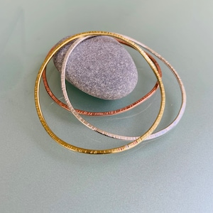 Trio of bangles, handmade in silver, copper & brass, nature inspired, textured and shaped, limpet design