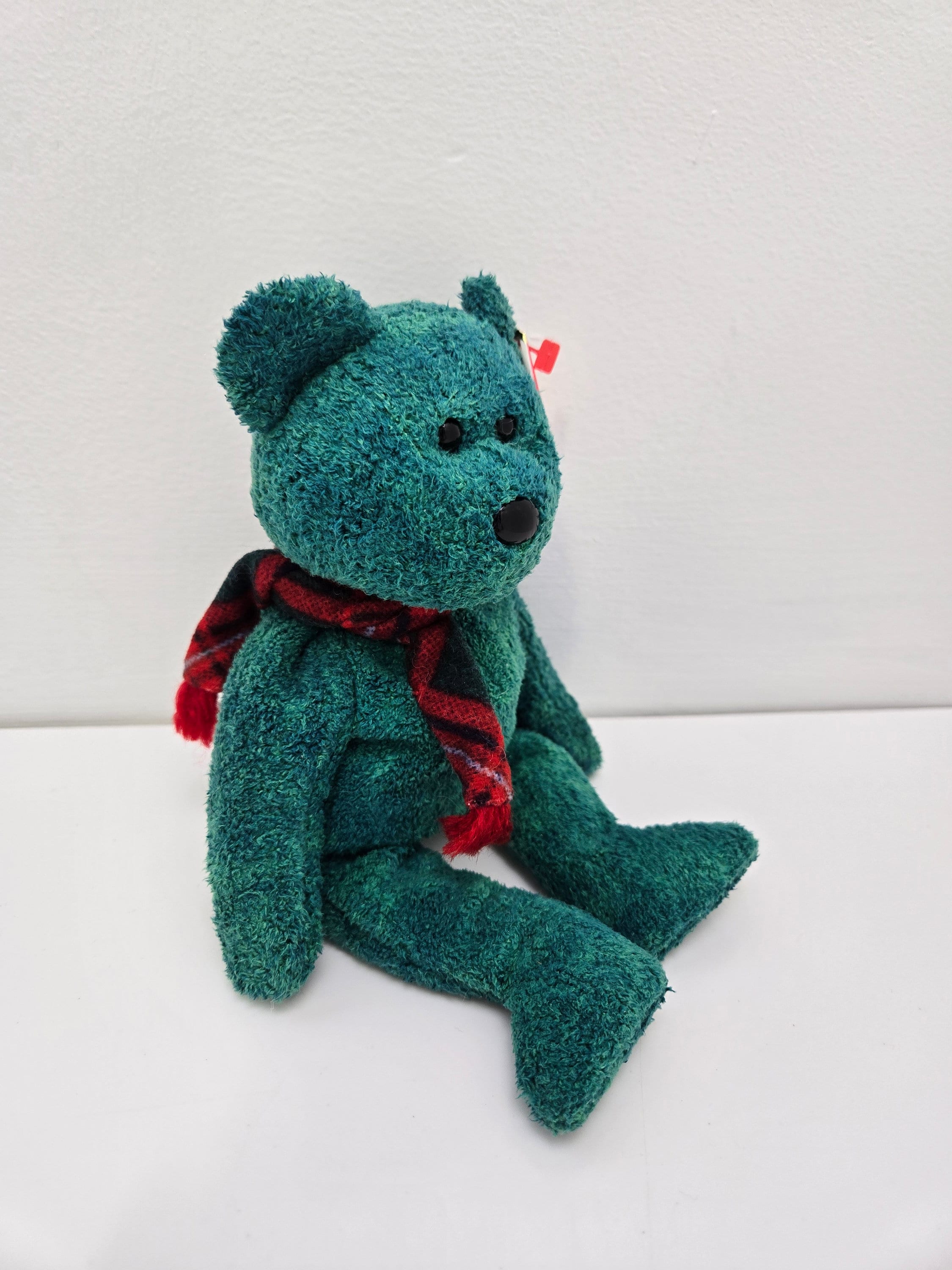 Ty Beanie Babyの「ウォレス」という名の緑色のホリデーベアが、赤い