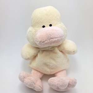 May include: A plush yellow duck toy with pink feet and a pink beak. The duck has black eyes and a soft, fuzzy texture.