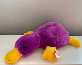 Peluche Ty Beanie Buddy “Patti”, el ornitorrinco morado (33 cm)