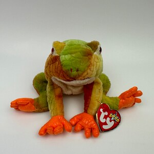 May include: Green and orange plush frog with a Ty tag that says "2000".
