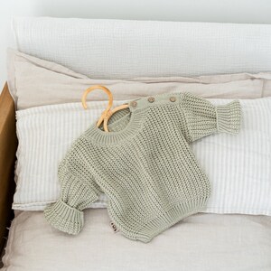 Newborn coming home outfit - baby knit sweater with buttons on the shoulder. Pregnancy Gift Idea